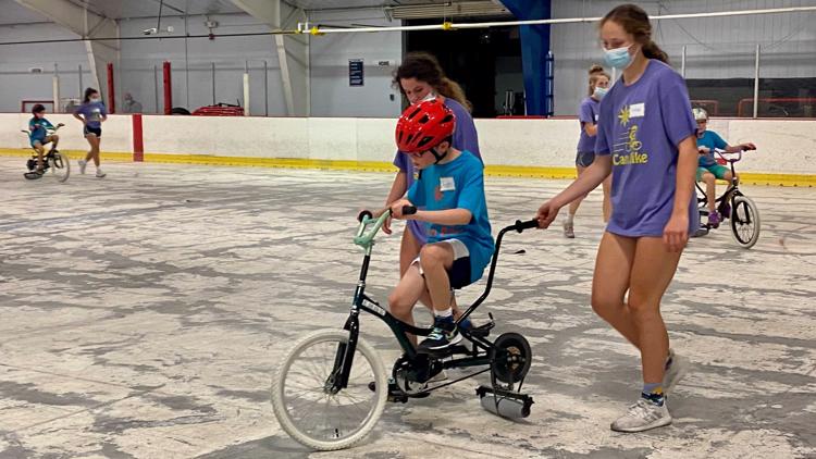 Kids with disabilities learn to ride a bike through week-long program