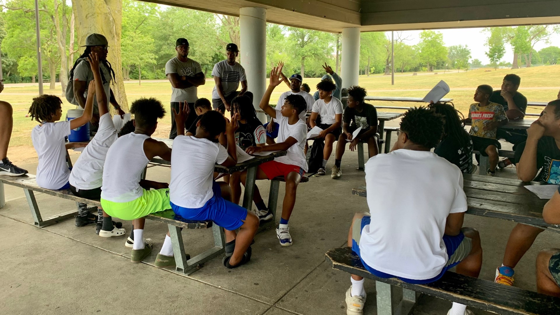 Every week, Kareem Hines and other mentors come to Lawrence Park to play football and have a community forum.
