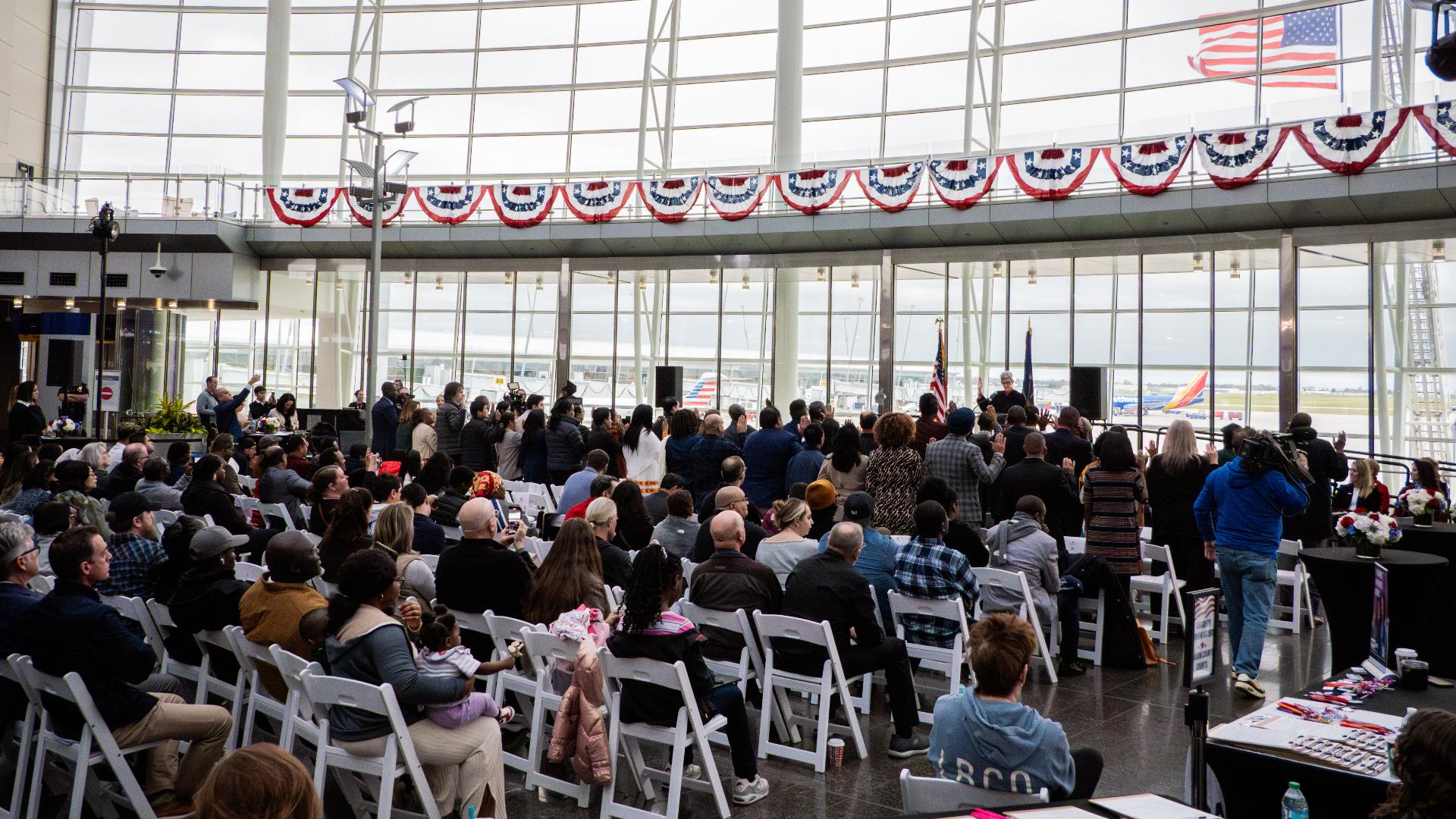 Forty-seven people were sworn-in at the airport Tuesday as U.S. citizens.