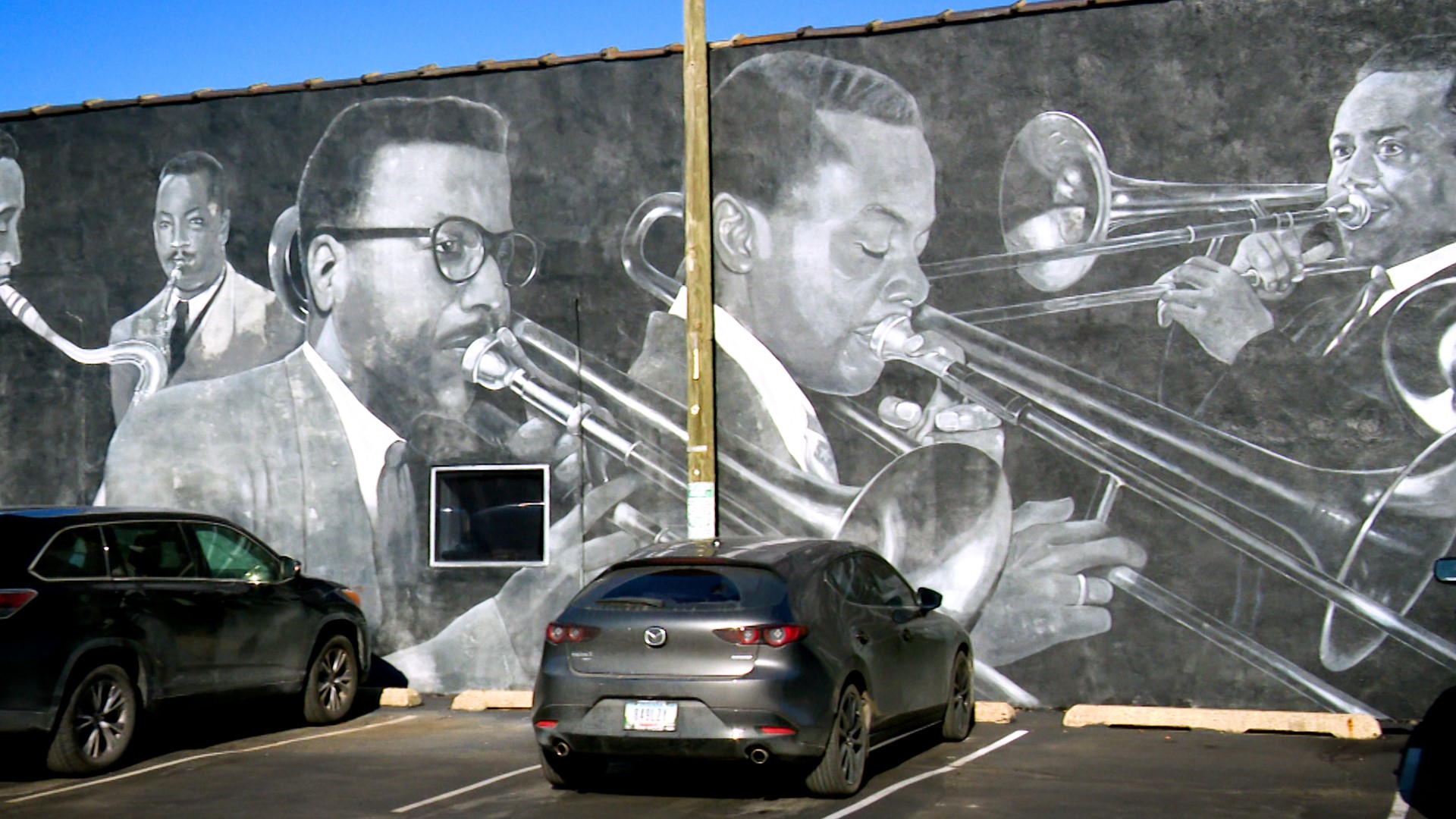 Tour guide Sampson Levingston showed Carlos the Jazz Masters Mural on the side of Musicians' Repair & Sales.
