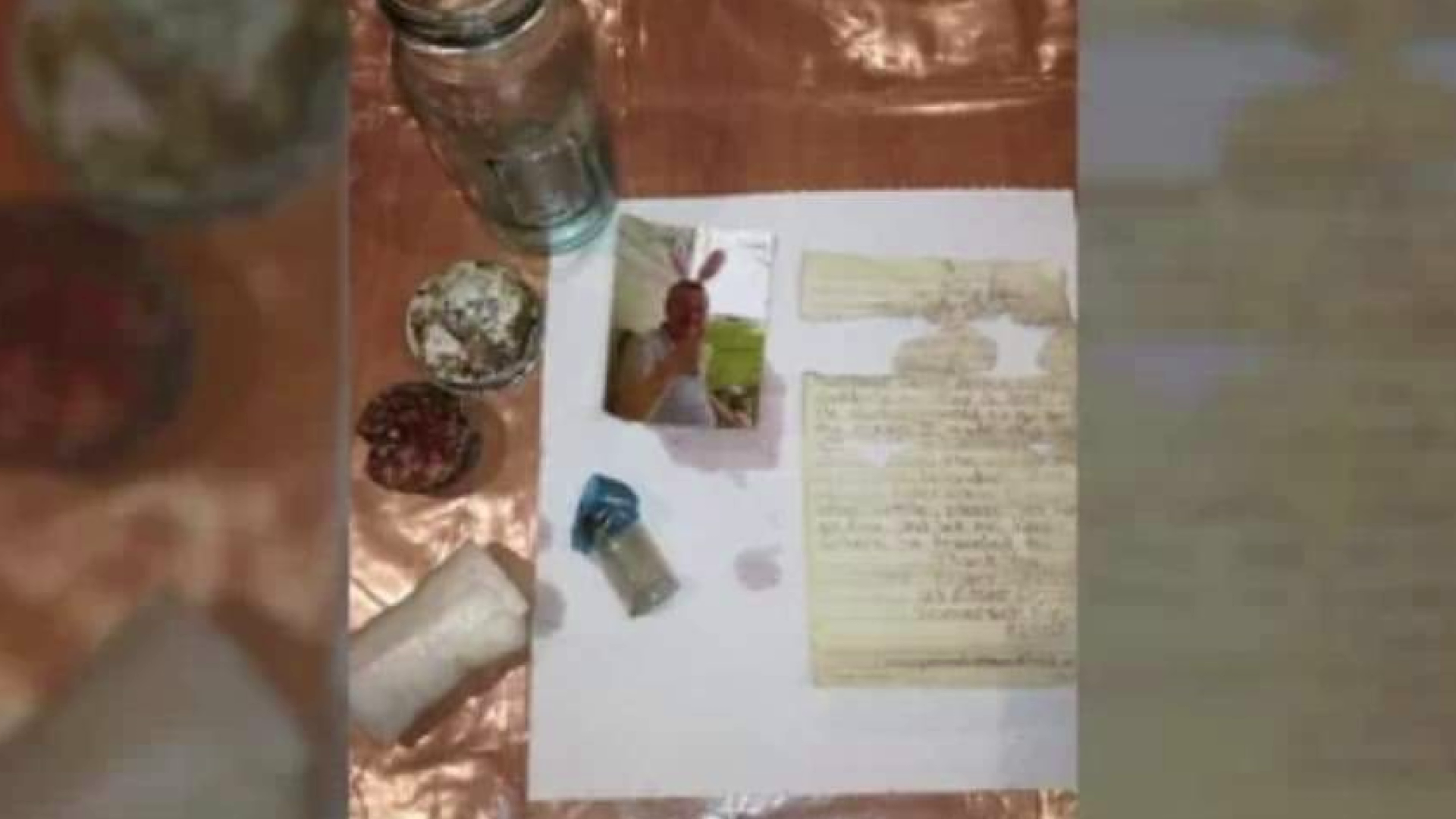 A bottle containing a photo and other items were found on a beach.