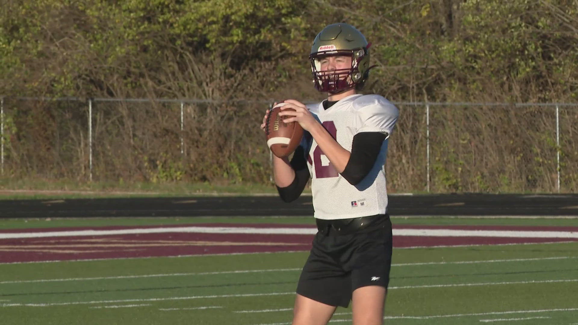 13Sports director Dave Calabro talks with the players and coaches of the Lutheran High School football team.