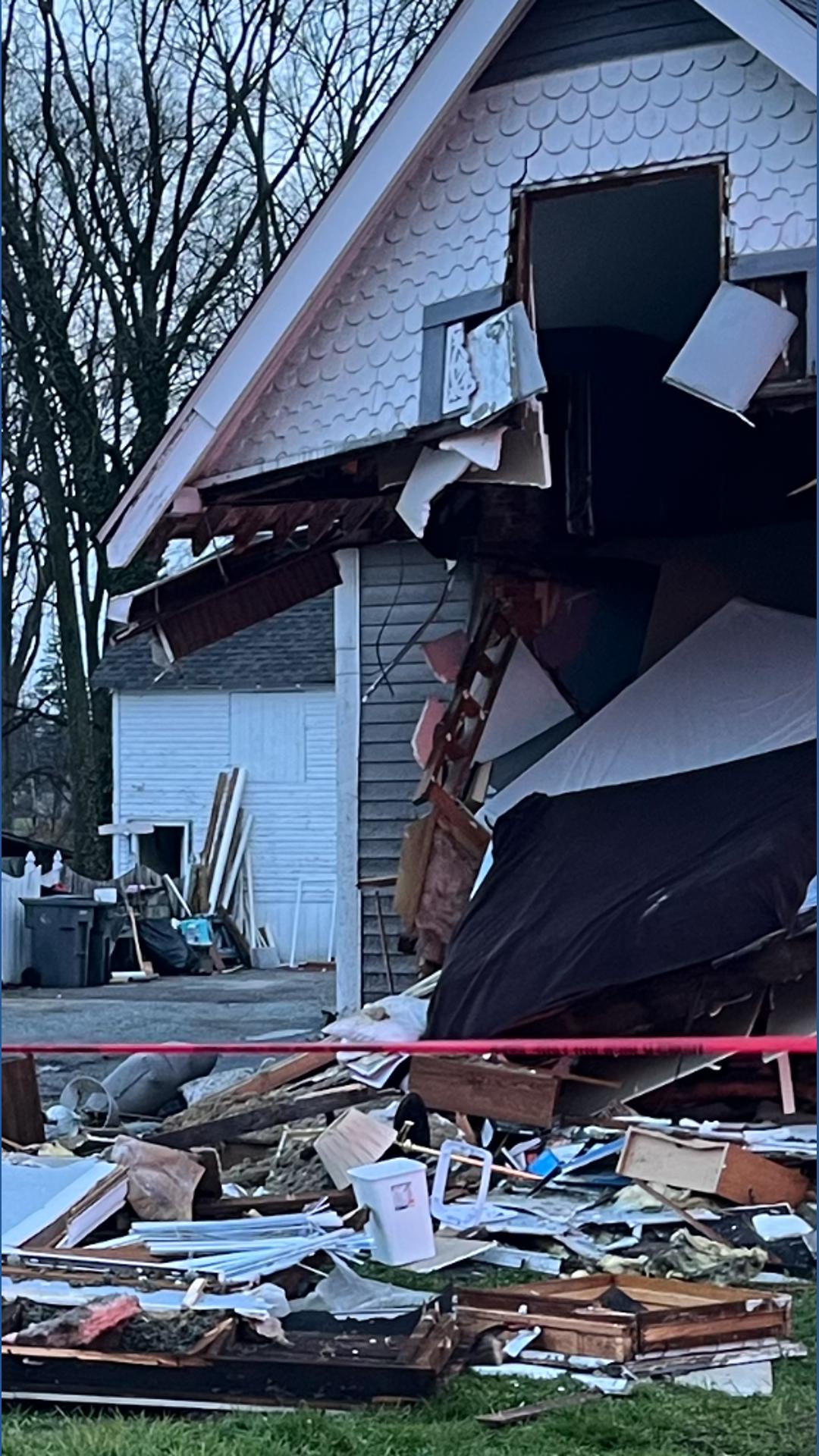 Driver hospitalized after pickup truck crashes into 2 homes on ...
