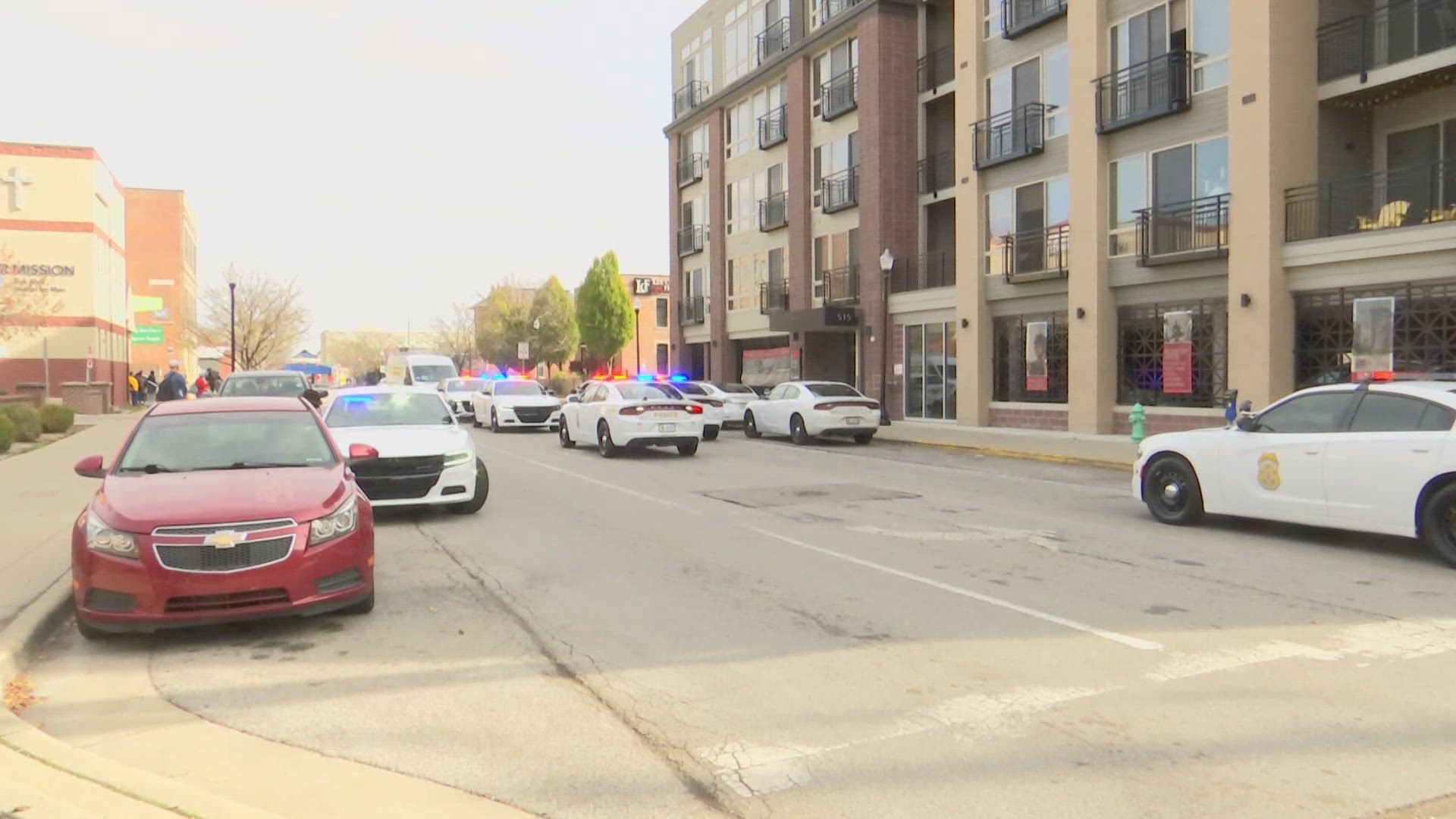 Tenants at the E'Laan Apartments in downtown Indianapolis watched from their balconies Sunday afternoon as IMPD cars flooded the street to respond to a shooting.