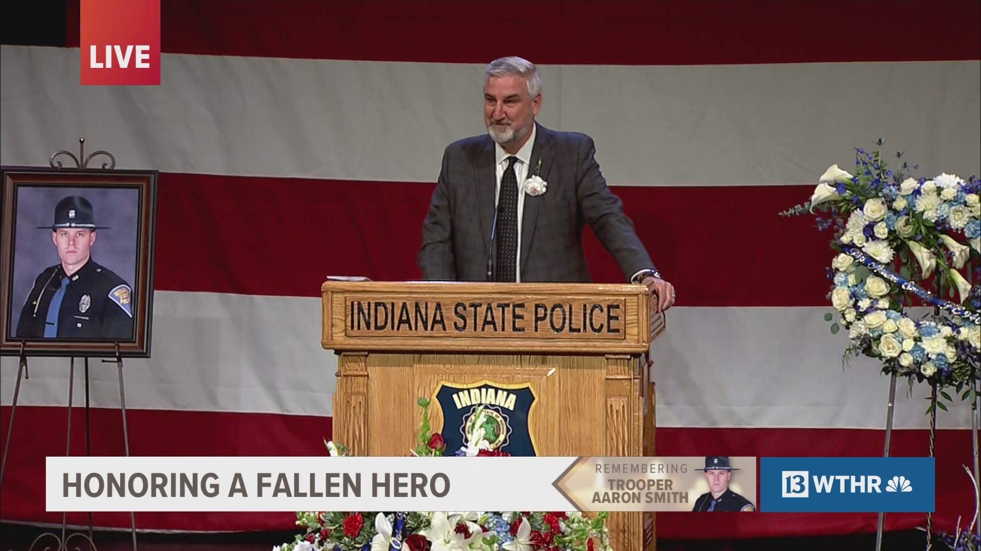Indiana Gov. Eric Holcomb honors fallen ISP Trooper Aaron Smith at his funeral service.