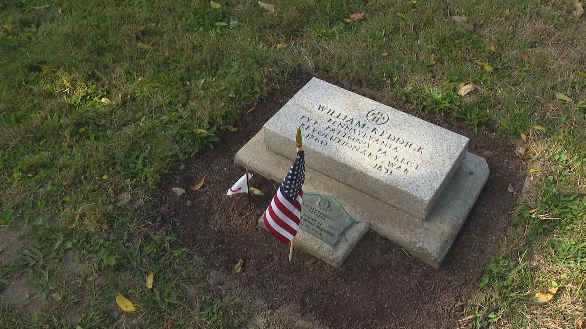 A sign banning foreign flags and limiting who can take care of gravesites at a Lawrence cemetery caught the attention of a retired teacher.