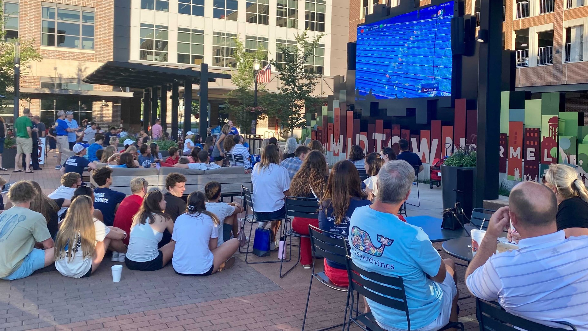 Swimmers, alumni, families and fans gathered at Carmel's Midtown Plaza to cheer on eight swimmers from the Carmel Swim Club during the U.S. Olympic Trials.