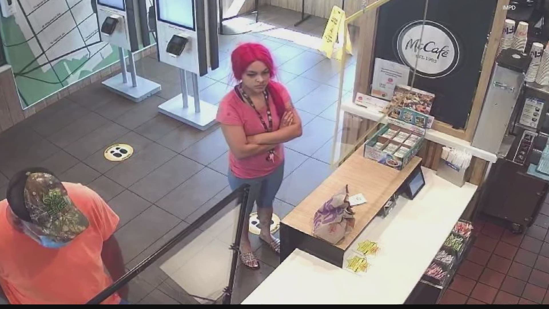 The recording shows a woman with red hair throwing several items over the counter.
