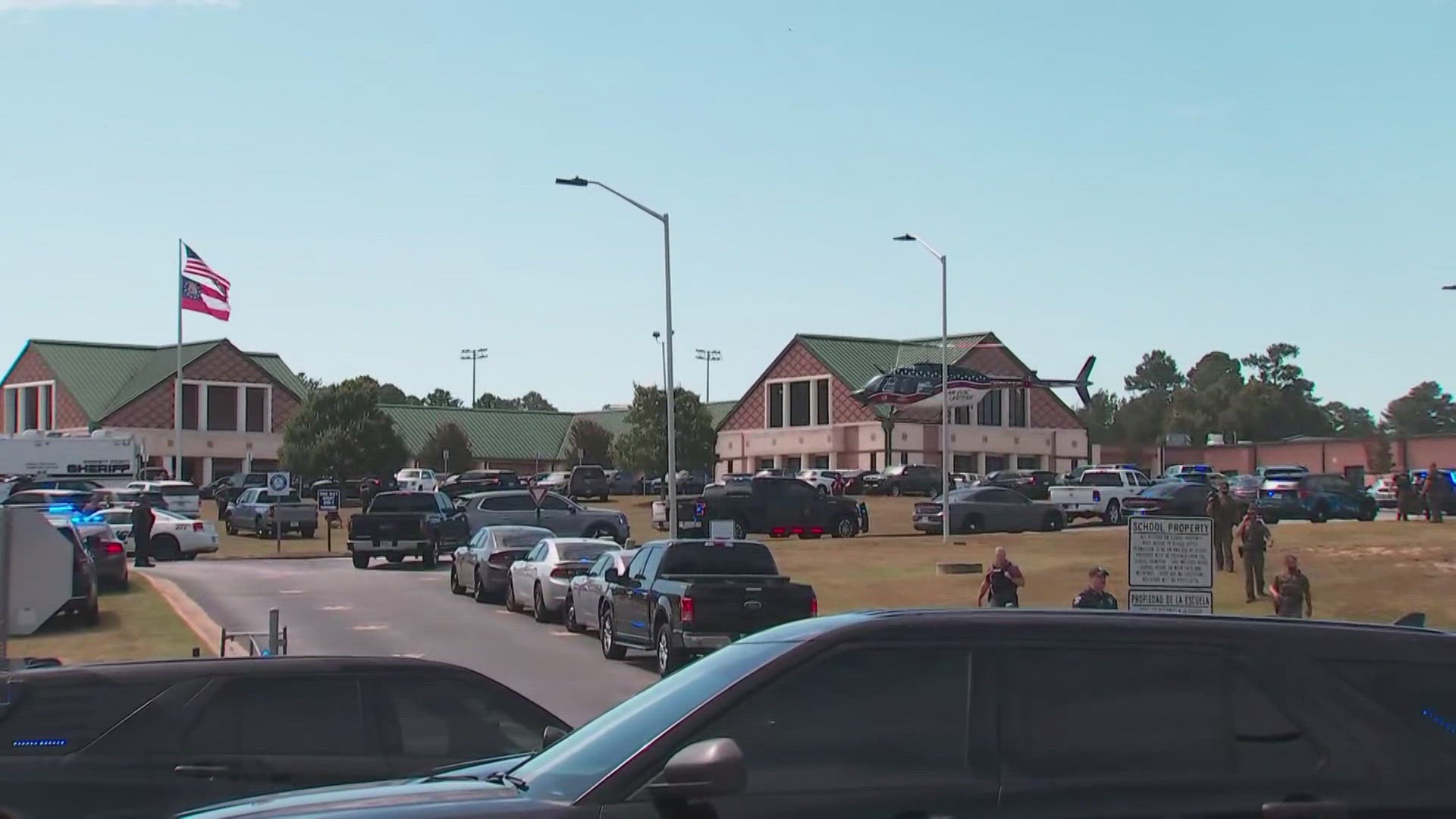 Helicopter video showed dozens of law enforcement and emergency vehicles surrounding the high school about 50 miles northeast of Atlanta.