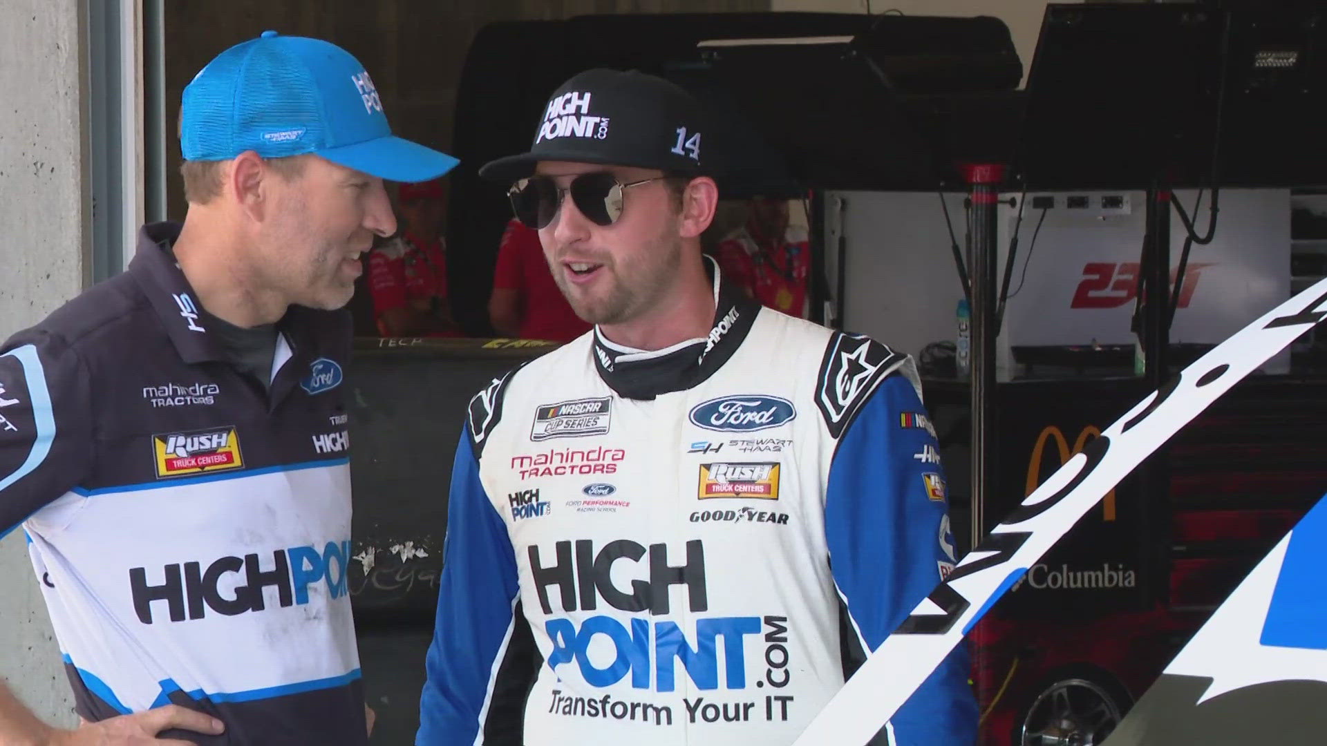 13Sports director Dave Calabro talks with Chase Briscoe during practice for the Brickyard 400.