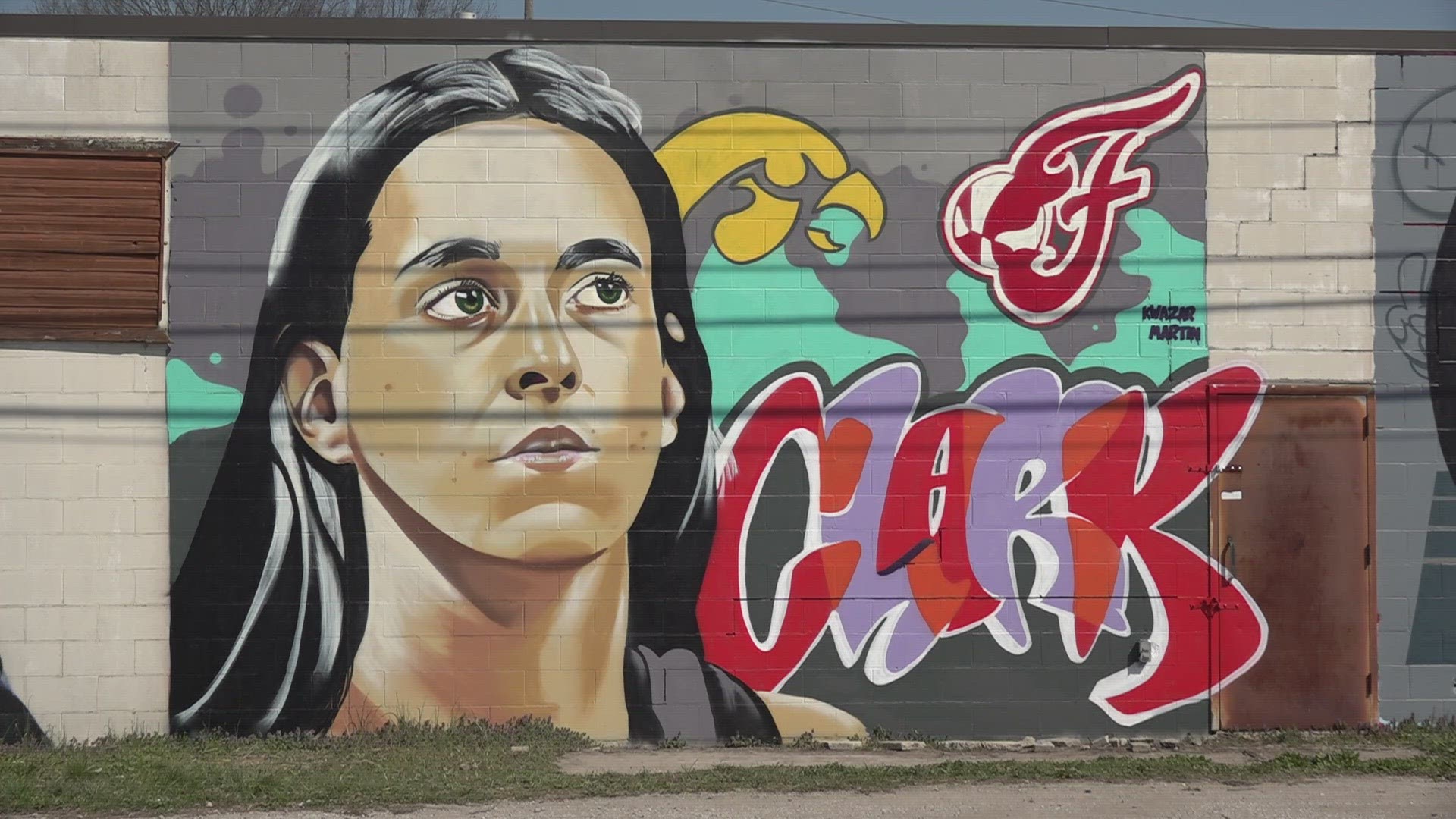 The mural is on the side of a building on West 18th street near East Riverside drive. Clark is expected to be the number 1 pick in this year's WNBA draft.