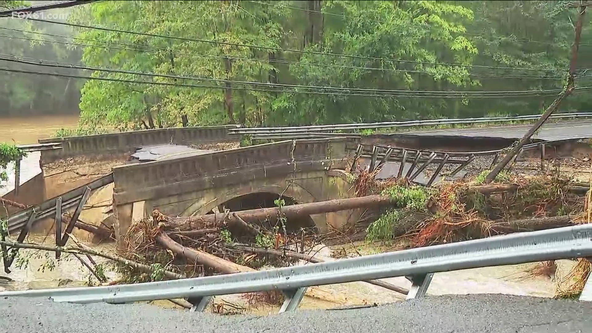 Connecticut residents clean up after heavy rain washes away roads ...