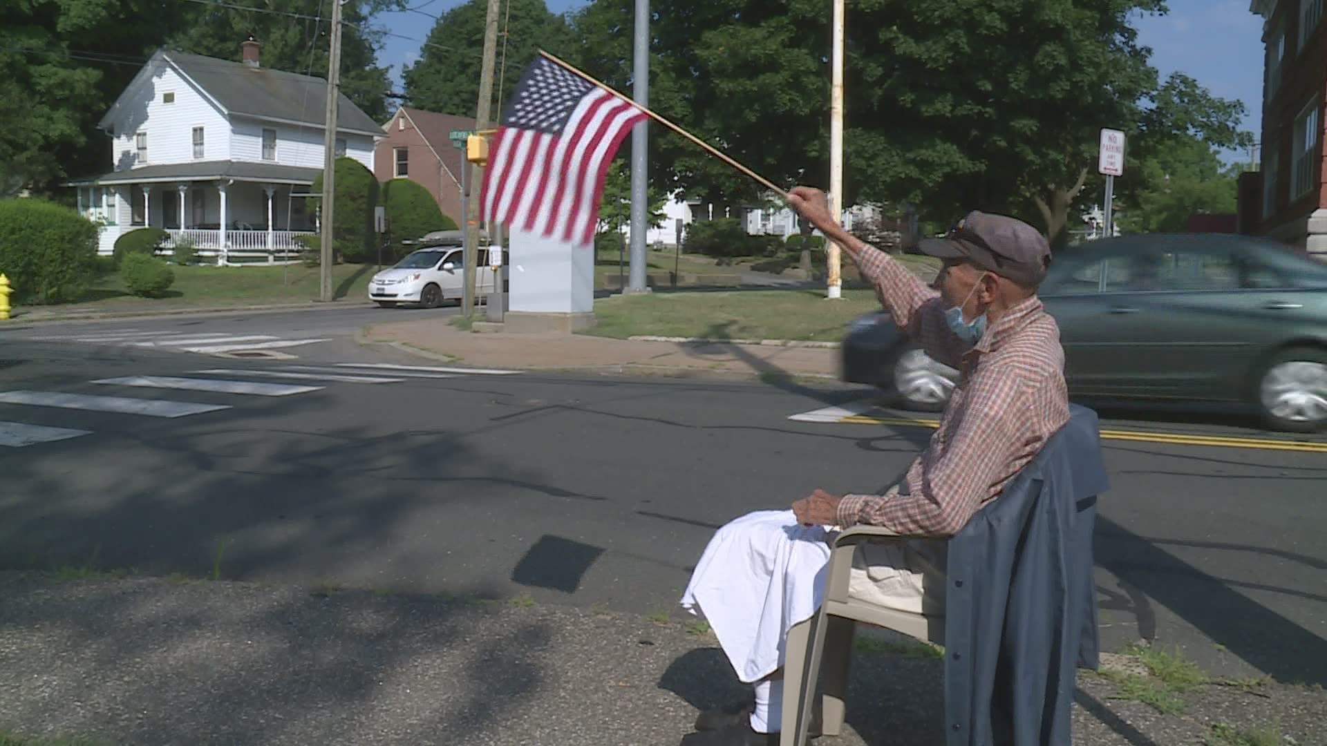 Every morning, World War II veteran Mastrocola grabs a lawn chair and an American flag and takes a seat on the sidewalk. It's part of his final mission in life.