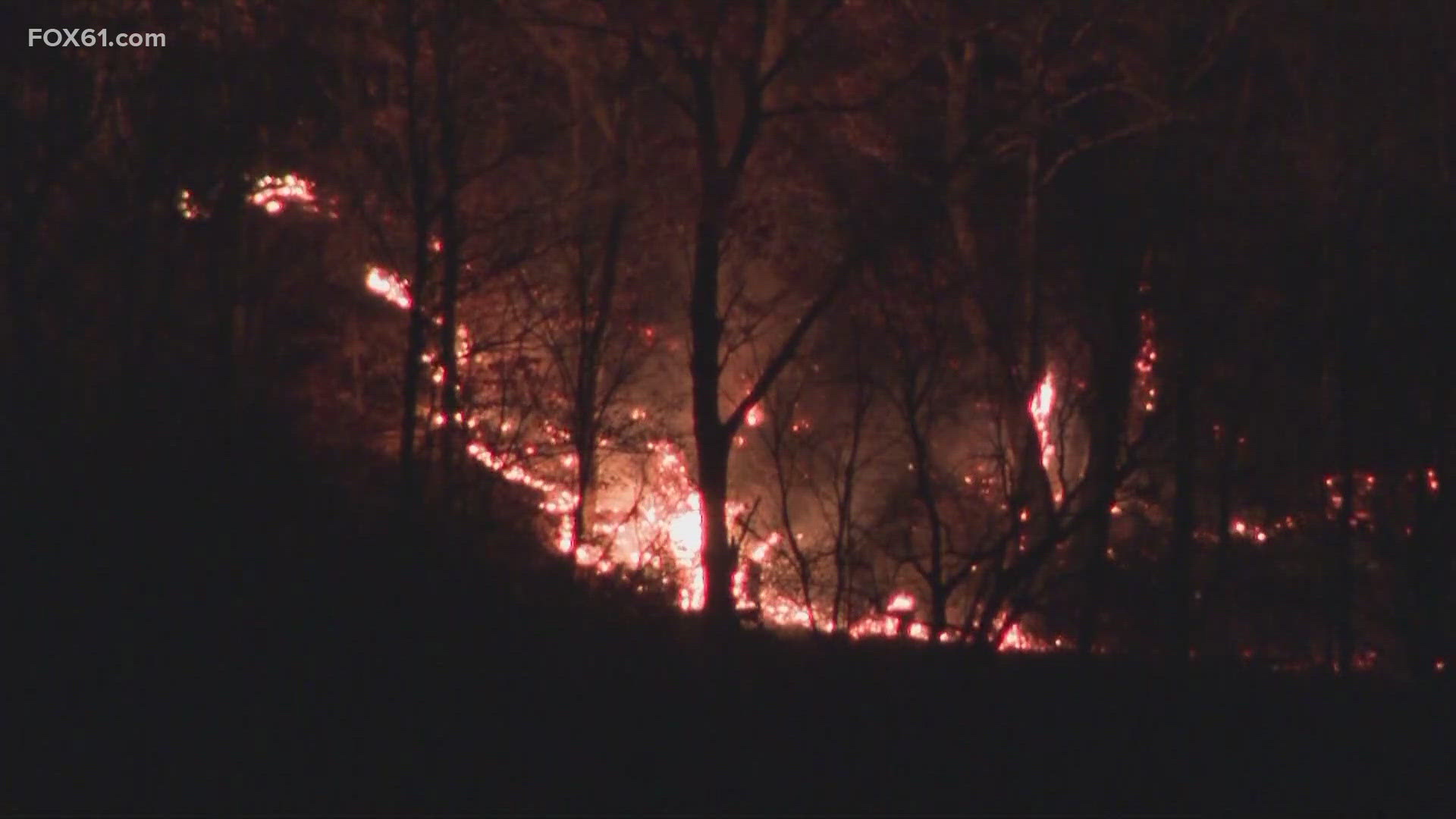 The Hawthorne Fire continues to burn Thursday night, as smoke pours from Lamentation Mountain. Flames could still be seen shooting through treetops.