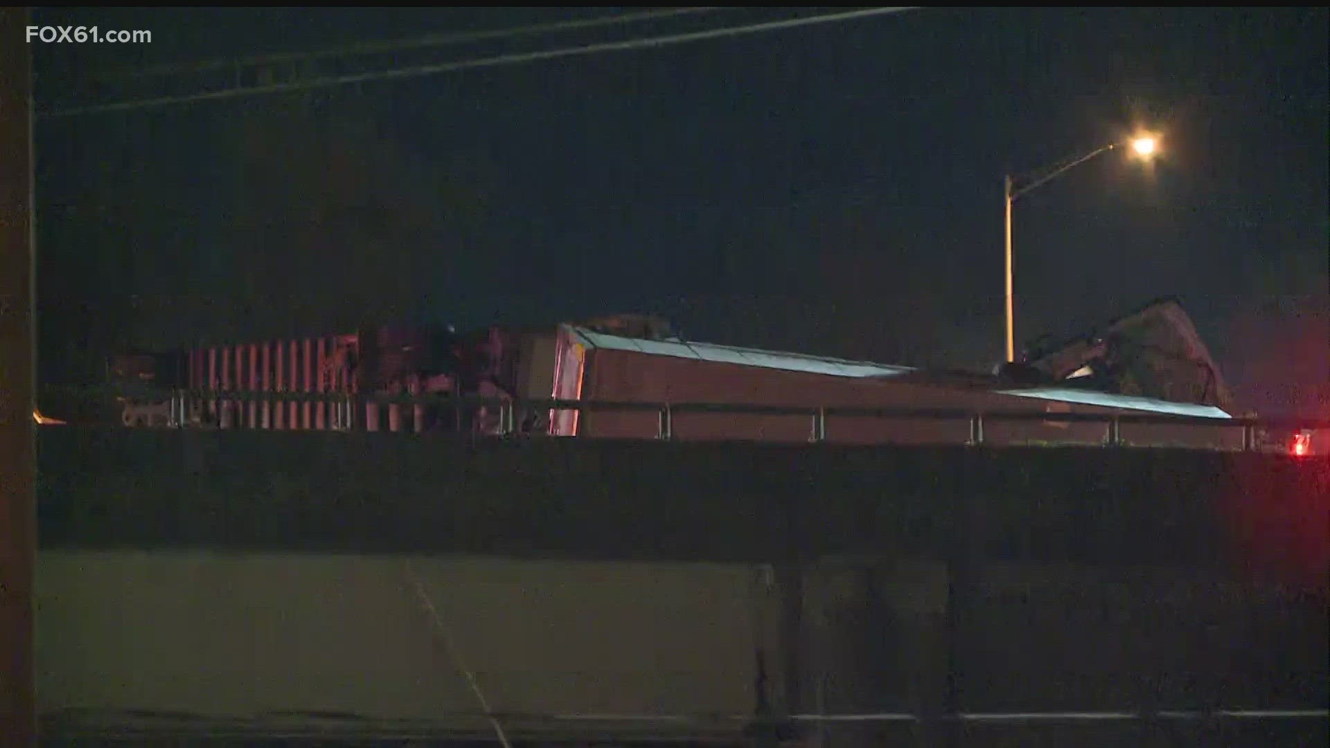 Camera footage on the highways shows part of the truck hanging over the highway barrier onto grass