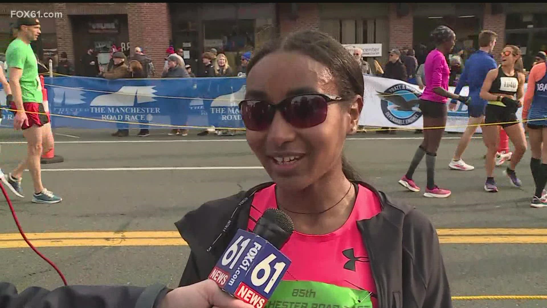 Weini Kelati finished first for the women's time at the Manchester Road Race and beat the time record.