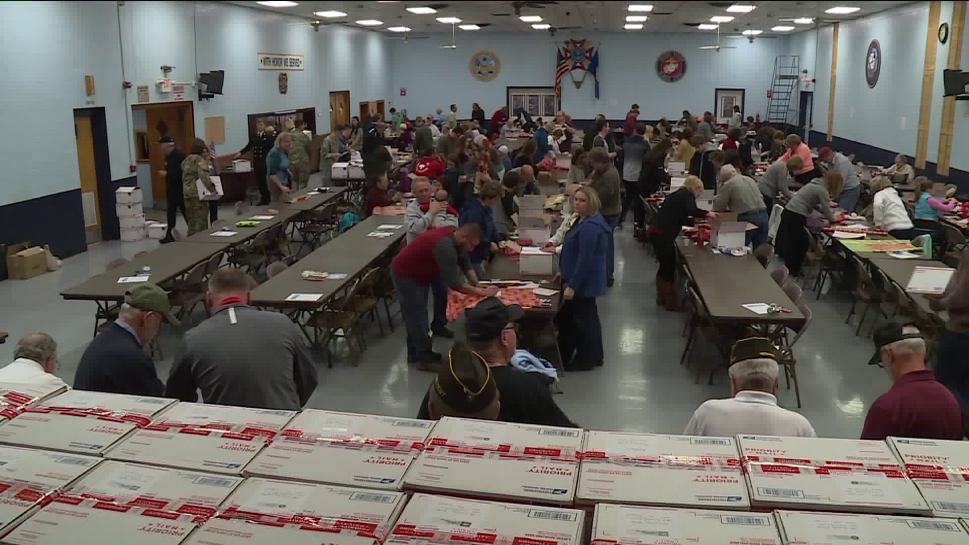 Community packs love and care packages for troops