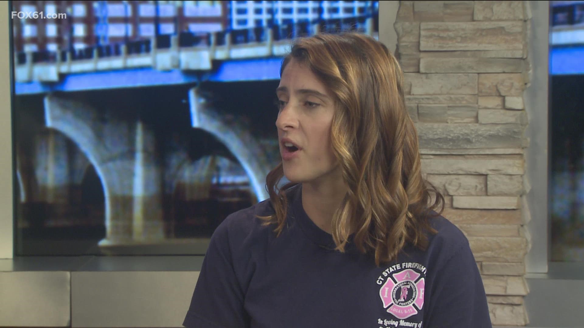 Anna Grudzinski, a firefighter at UConn fire department and member of the IAFF Local S-15 CT State Firefighters, shares pink t-shirts for breast cancer awareness.