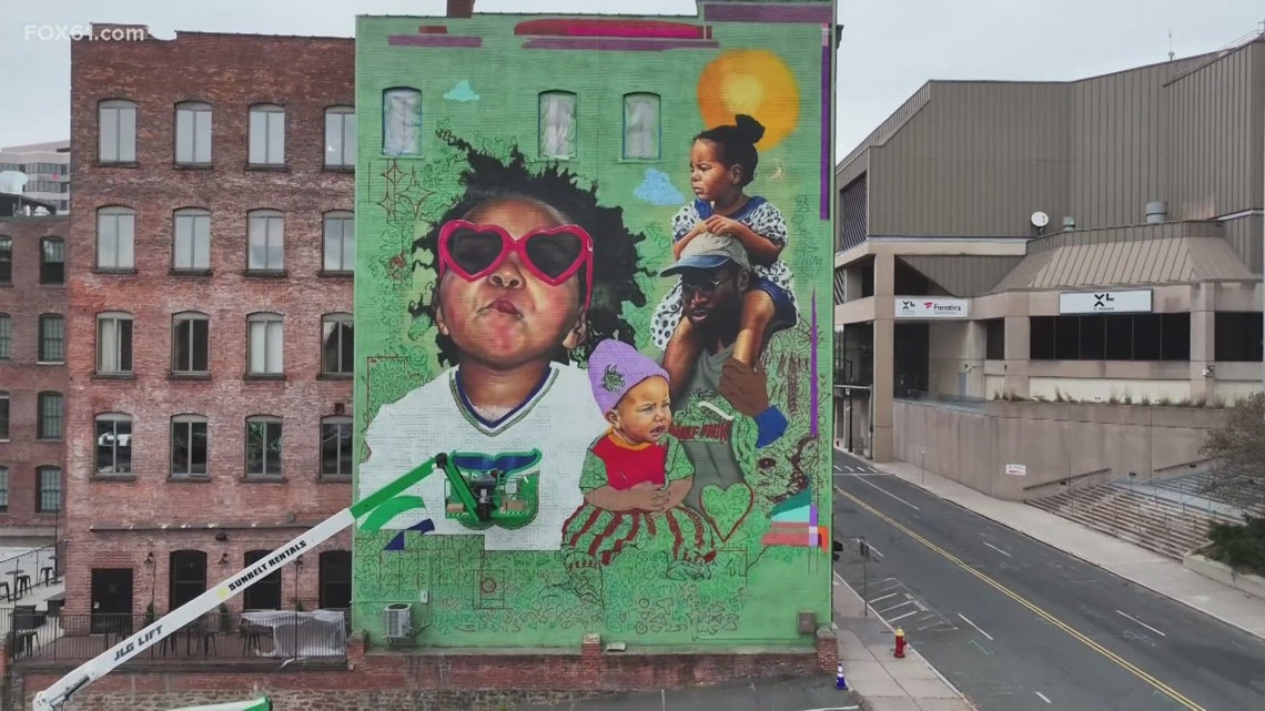 Artist works on 12th mural project in the Greater Hartford area