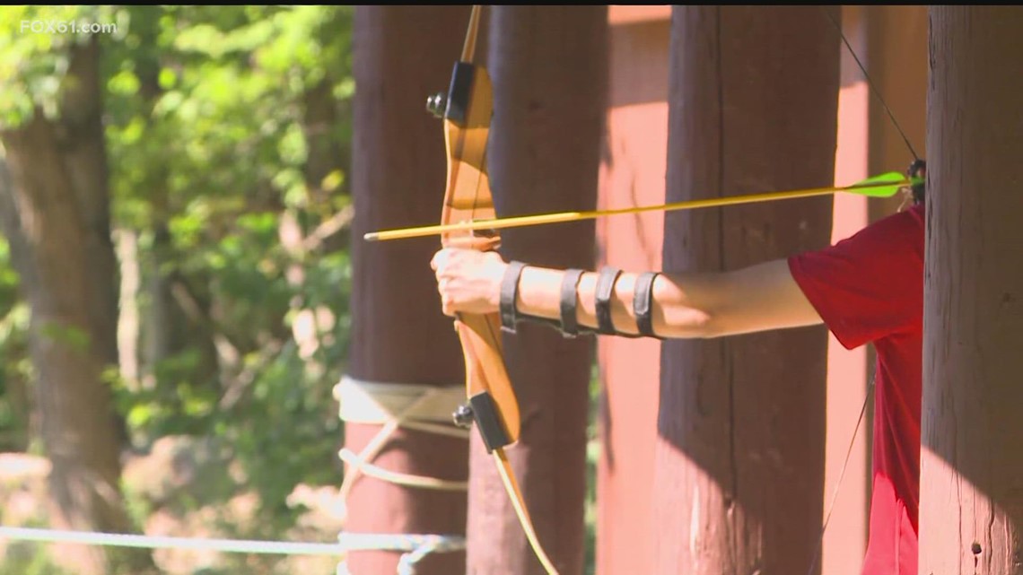 Young adults work towards merit badges with archery at Camp Sequassen