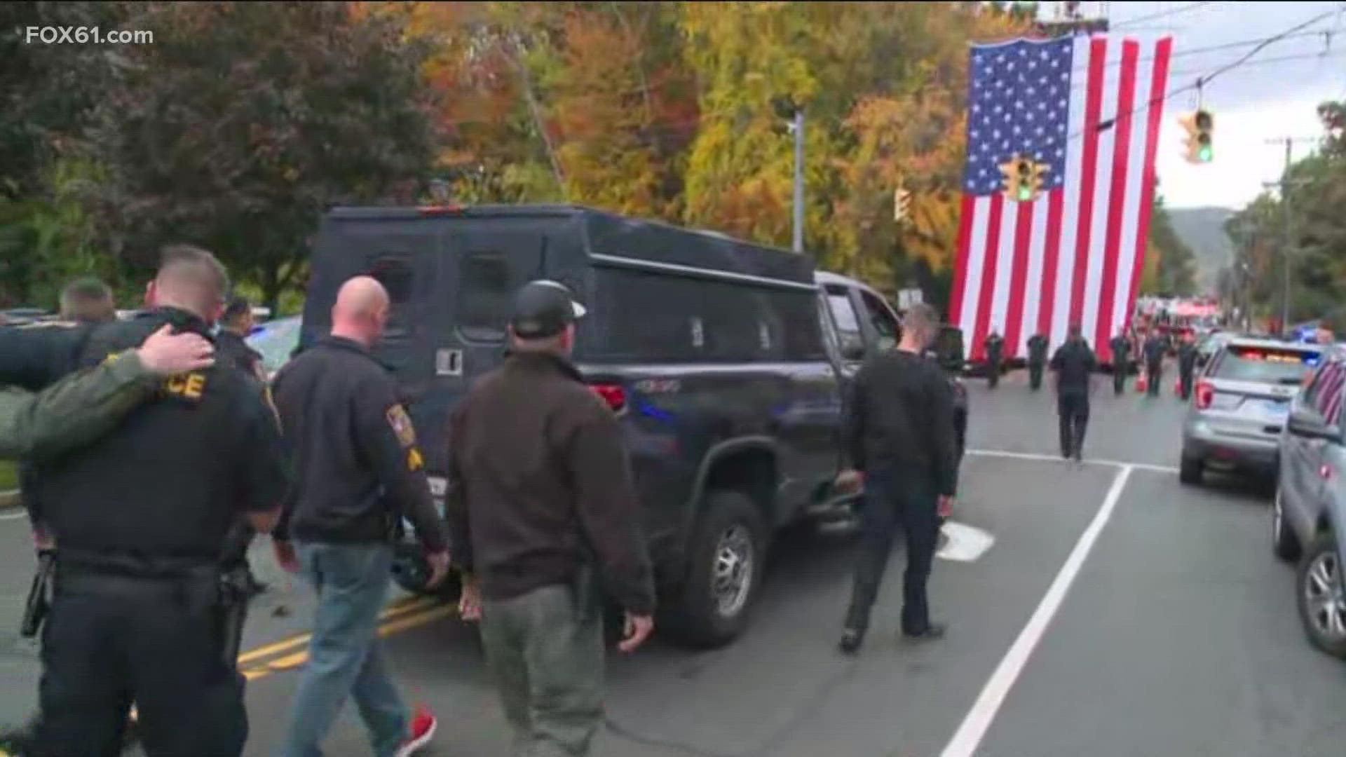 Police from across Connecticut gathered for a silent procession of one of the officers killed in the Bristol shooting.