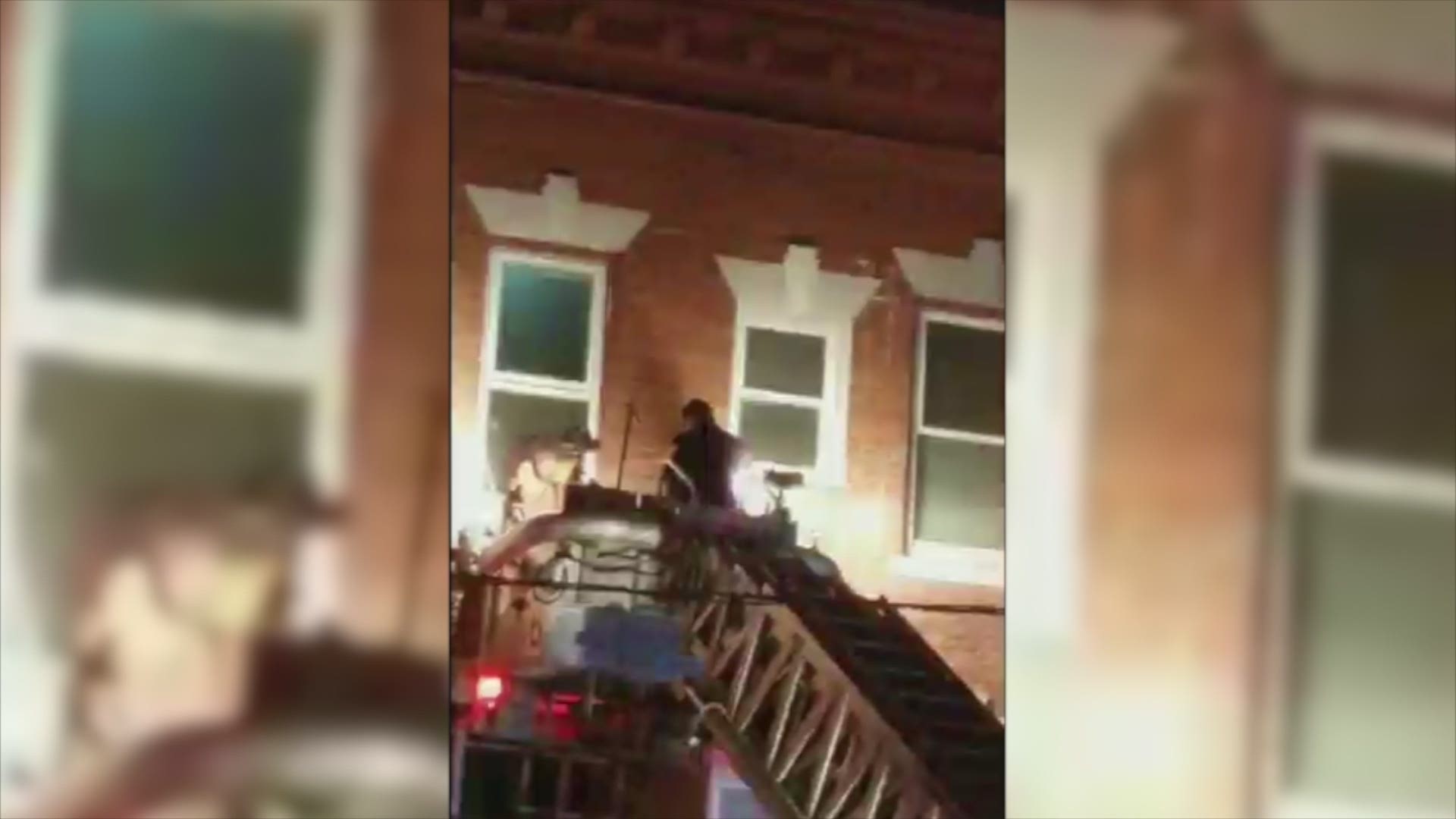 Firefighters were seen using a ladder truck to rescue a person from the third floor of the Bond Street apartment building.