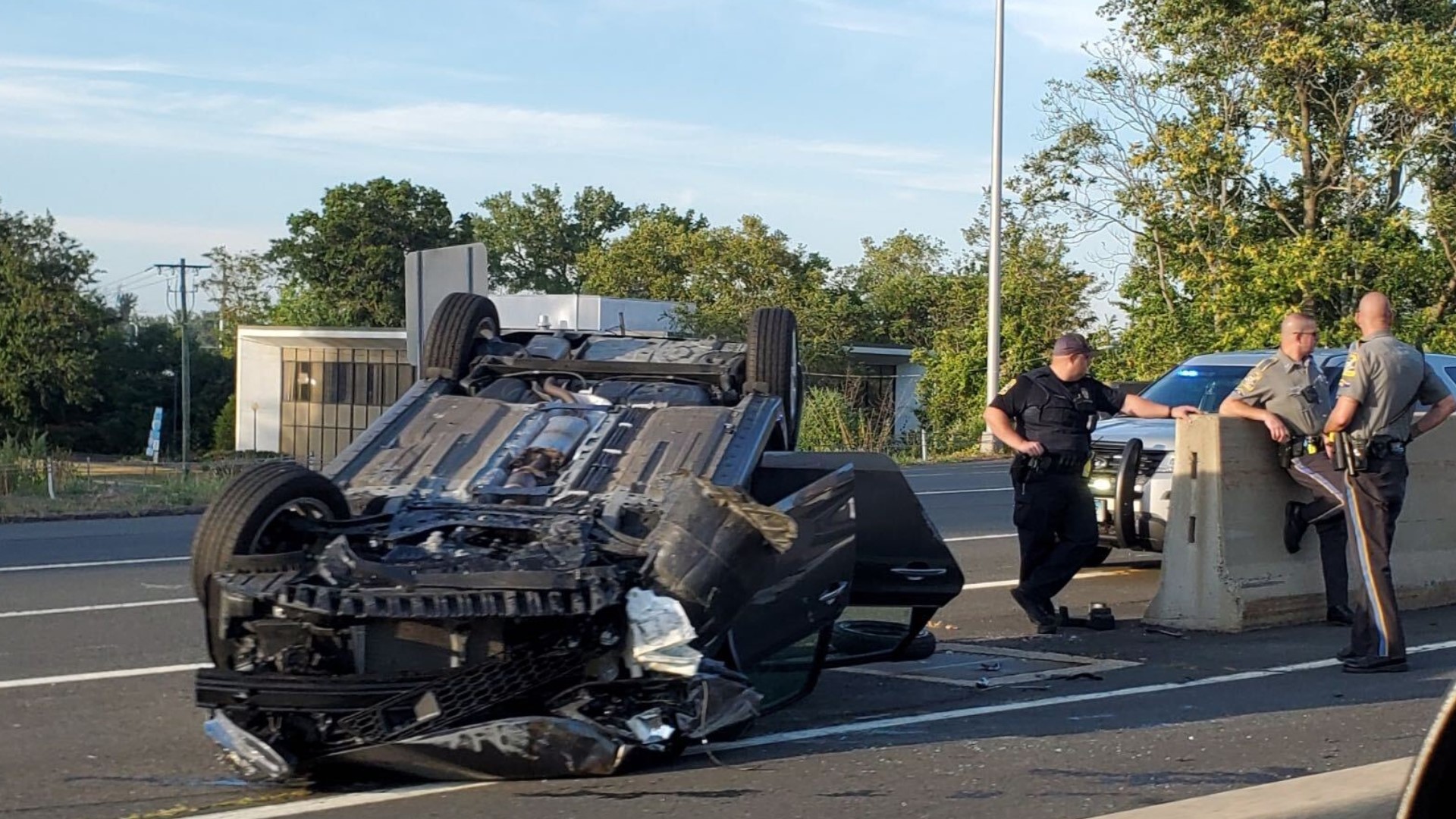 Car flipped upside down on bridge in Hartford