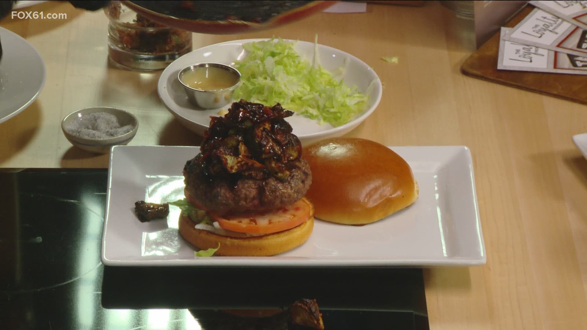 Wood-n-Tap shows off its winning burger from a hamburger showdown its chefs competed in.
