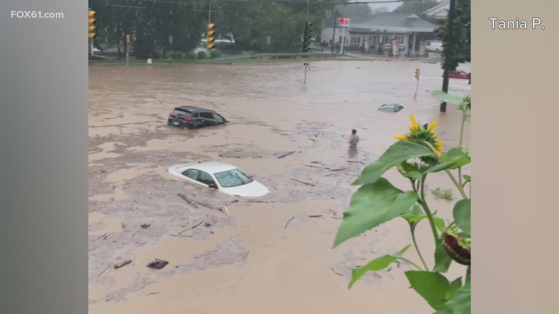 Heavy rain caused flooding to engulf towns like Southbury and Oxford while washing away roads and prompting some to be saved from the rising water.