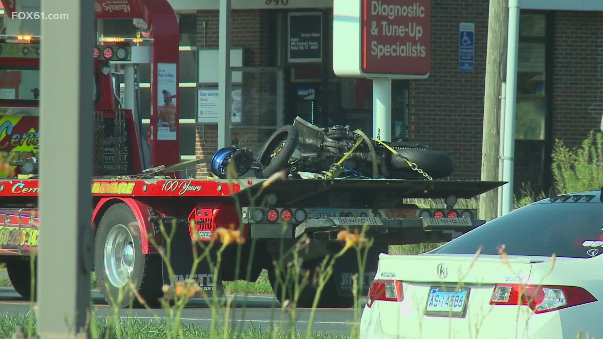 A motorcycle hit a vehicle coming out of a parking lot.