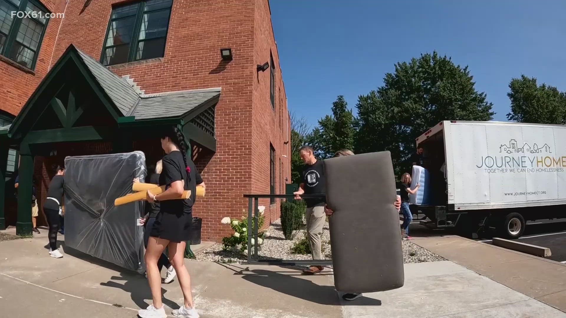 The Journey Home nonprofit, along with Johnson Brunetti volunteers, delivered furniture to a Hartford family Thursday.