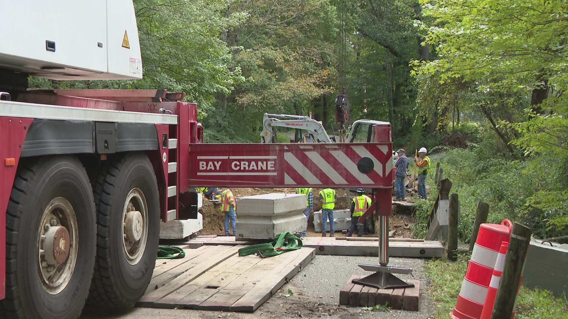 Crews worked to install a temporary ramp on Tuesday that is set to open Wednesday after two bridges on Brook Road washed away during heavy rain and winds.