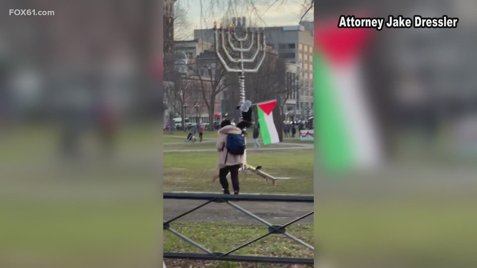 A video shows a group of protestors placing a Palestine flag on the Menorah in the New Haven Green.