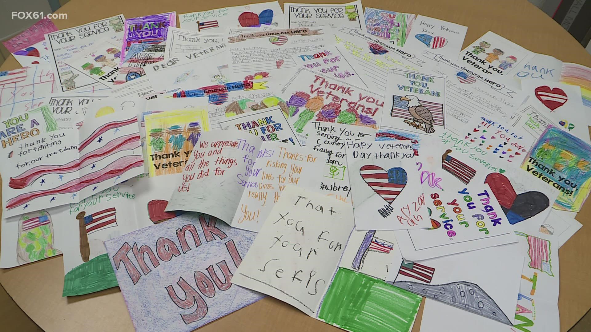 40 students created 284 cards at Maple Street School and they won a gold trophy for creating the most cards for veterans.