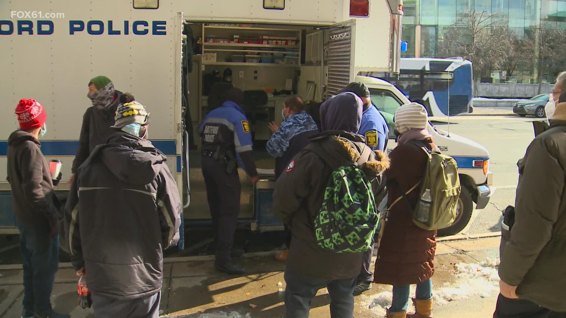 Volunteers with Hartford Police are distributing winter gear to those without a home in the Capital city.