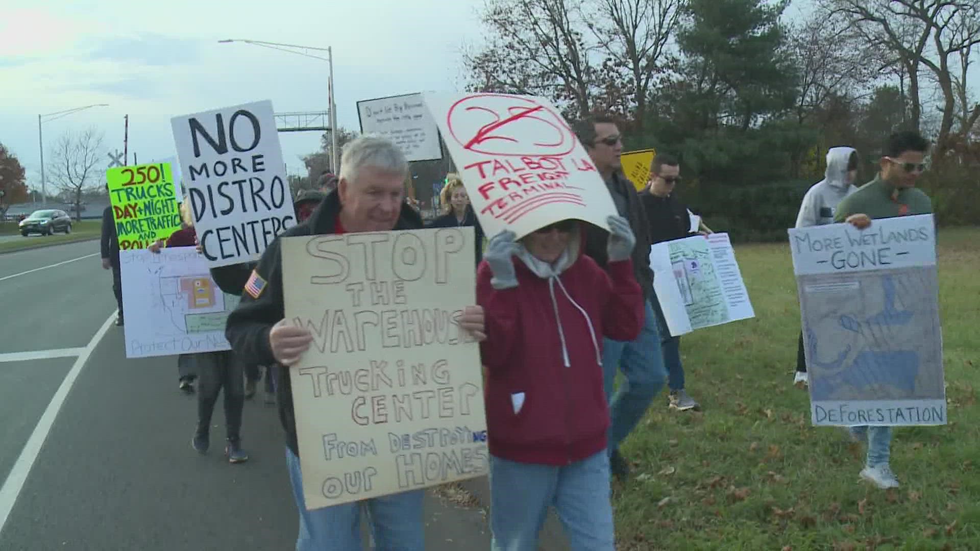 Residents protested against development plans for a new warehouse in South Windsor Sunday.