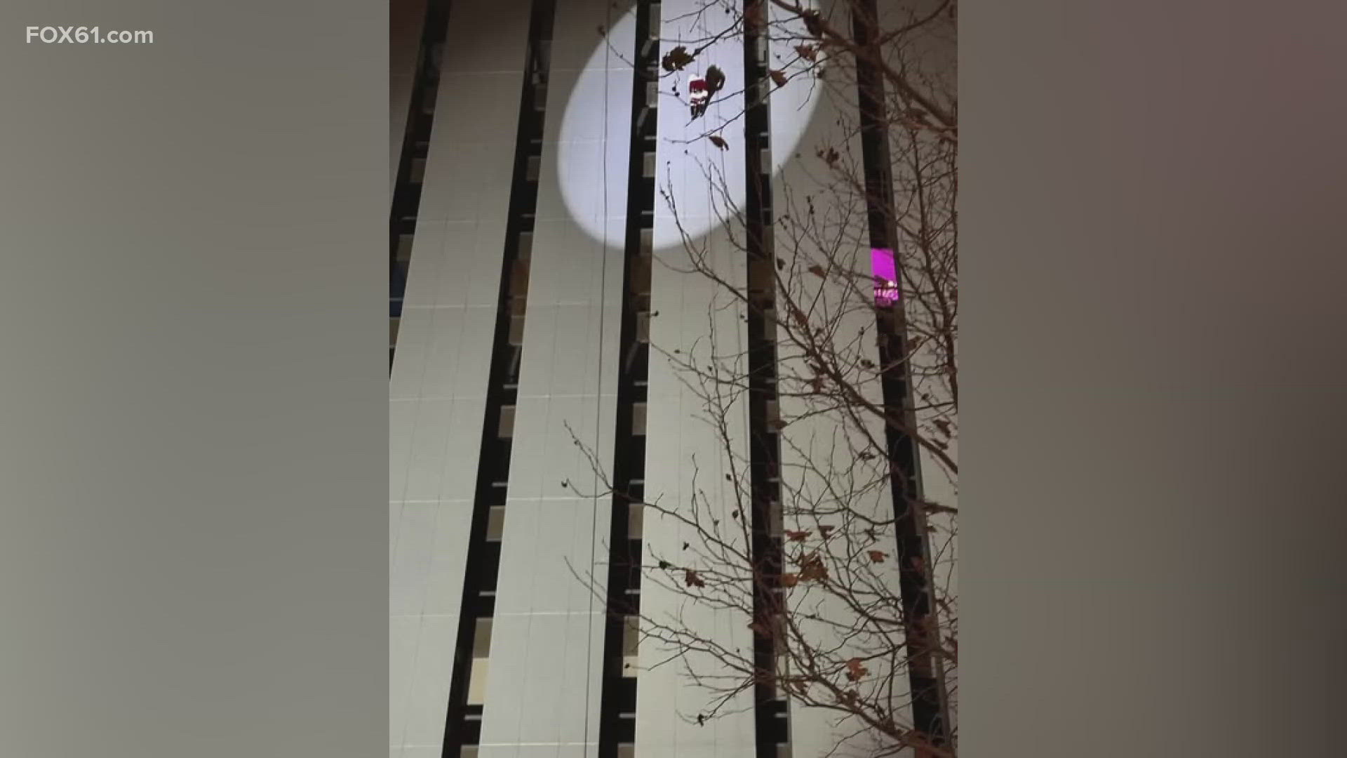 The Local 830 City of Norwalk Fire Department said a person dressed as Santa Claus was rappelling down the side of a 13-story building when his costume got stuck.