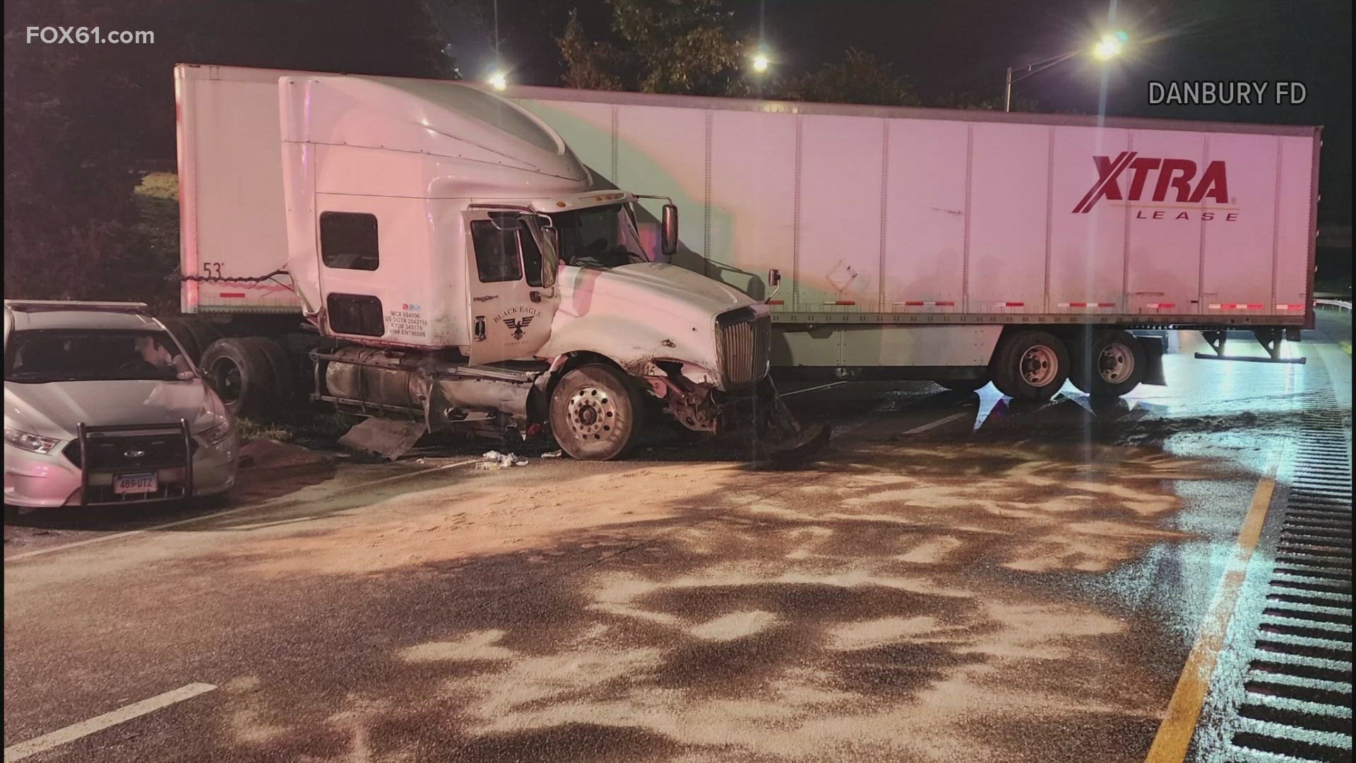 Officials were investigating a tractor-trailer crash when another truck lost control and hit a state police cruiser.