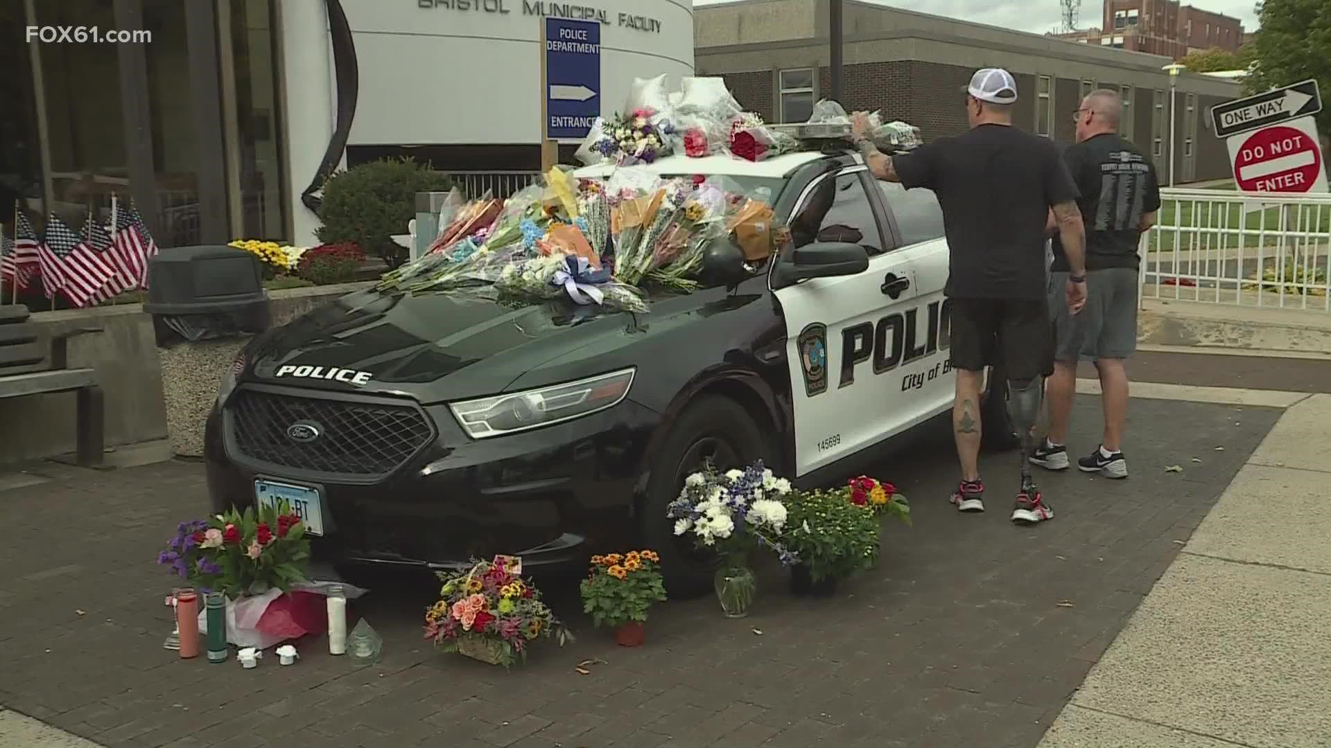 People have been placing flowers on a police vehicle to honor the officers who were killed late Wednesday night.