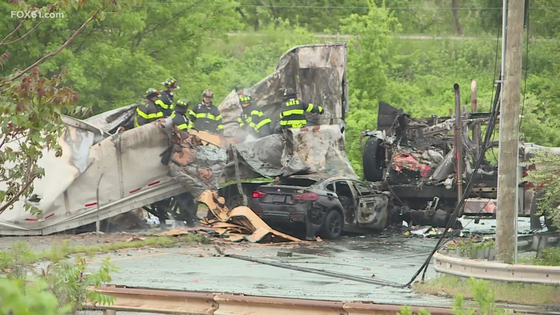 A black BMW crashed into the passenger side of a tractor trailer, resulting in a fire that caused significant damage.