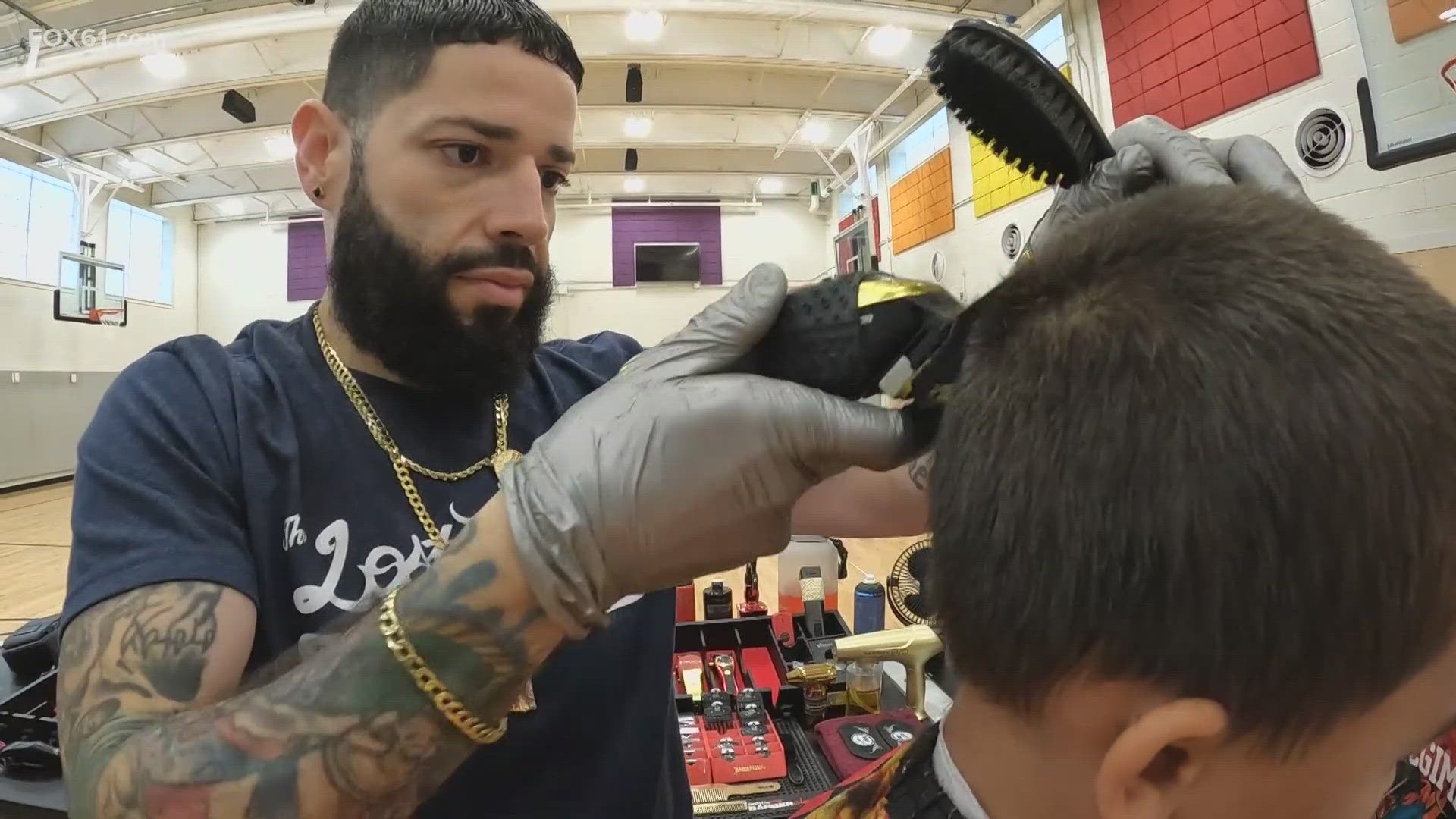 The team from Newington-based Lost Art Barbershop donated their time and talents to provide free haircuts to kids in New Britain.