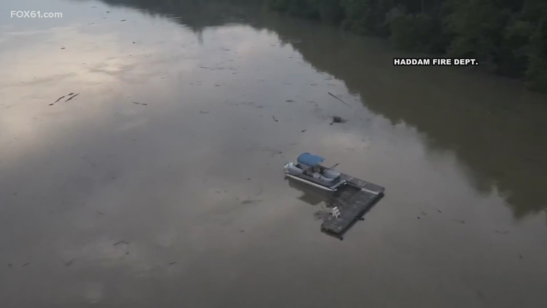 A dock with boats attached to it floated down the river.