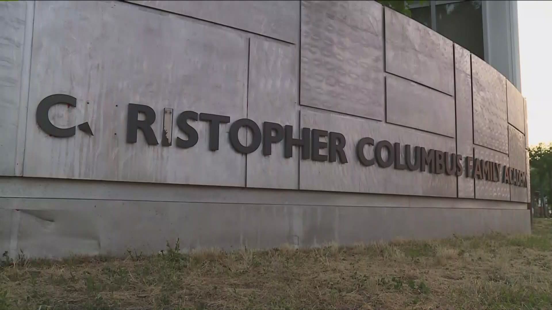 A group of demonstrators gathered out front of the former Christopher Columbus Family Academy to celebrate the decision to change the schools name.