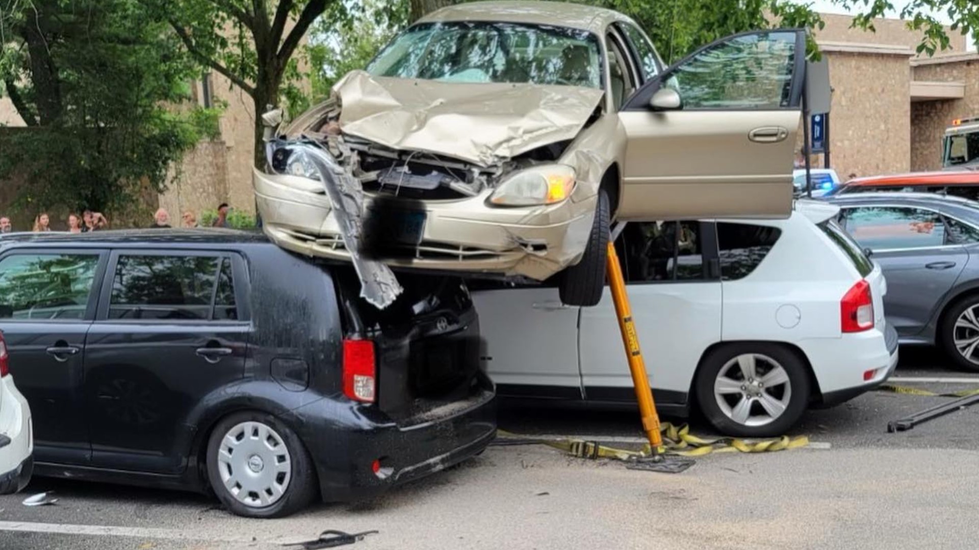 Car found on top of two vehicles in Connecticut
