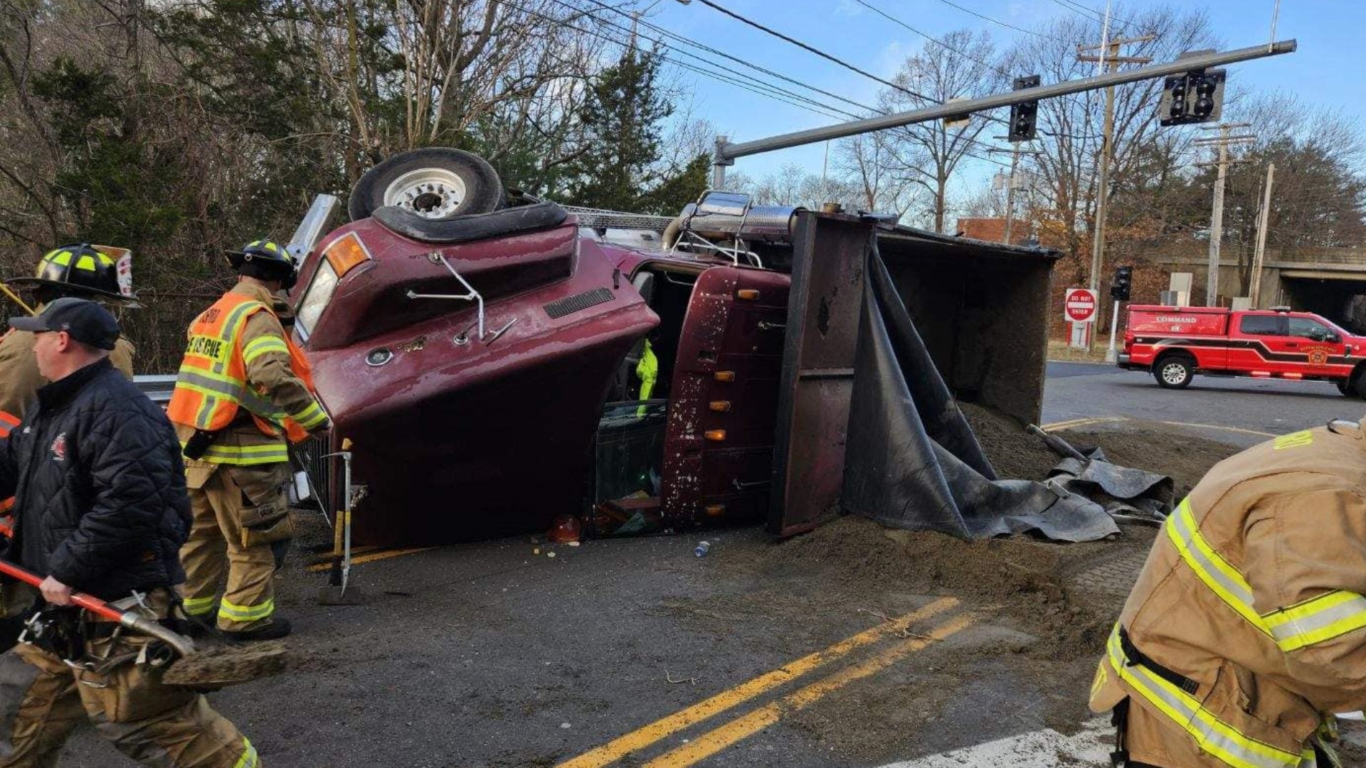 A dump truck carrying a full load of sand rolled over on Schoolhouse Road near Interstate 95 exit 35 in Milford.