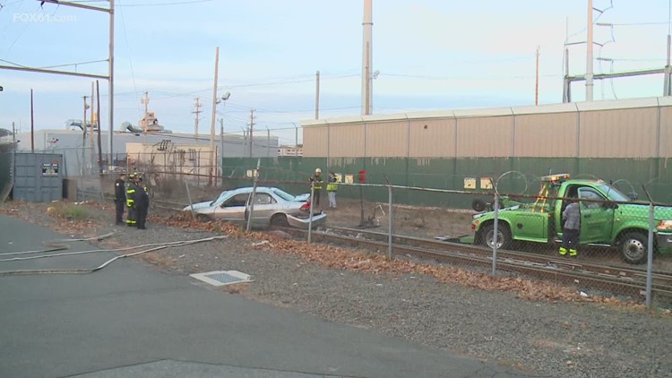 Car hit by moving train in New Haven