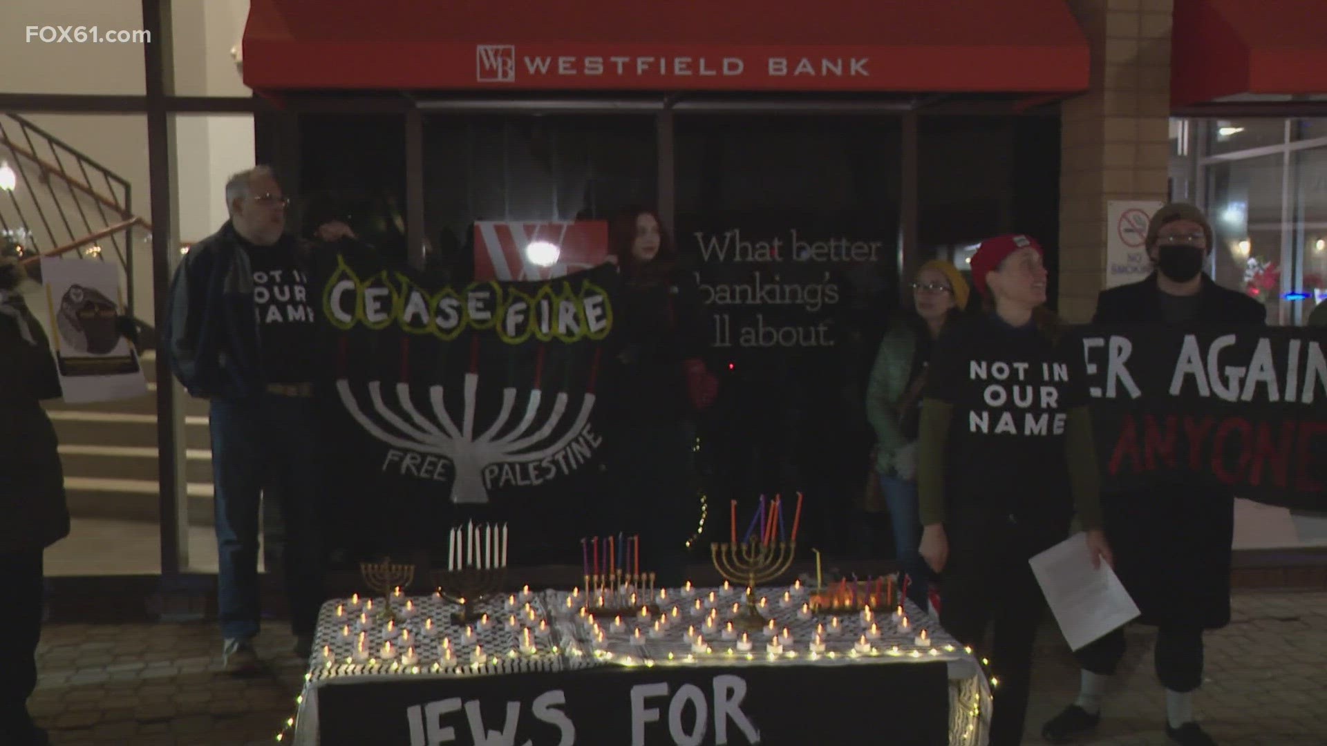 Jewish people in the crowd lit the menorah to celebrate Hannukah and used their faith to stand in solidarity.