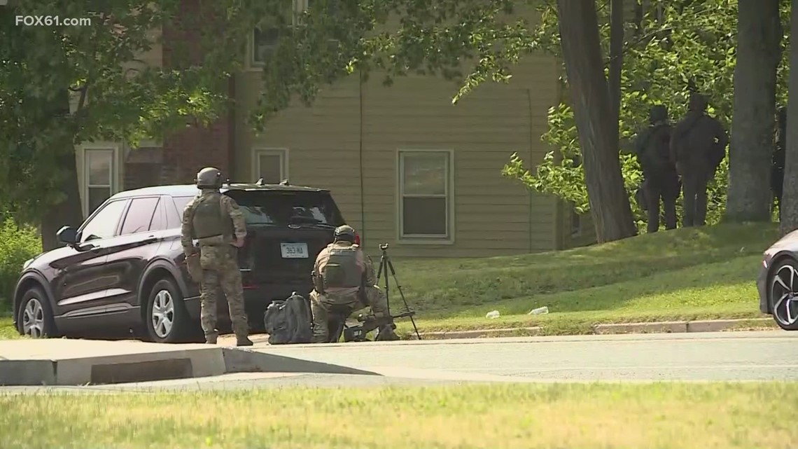 SWAT team and Manchester police in standoff at house