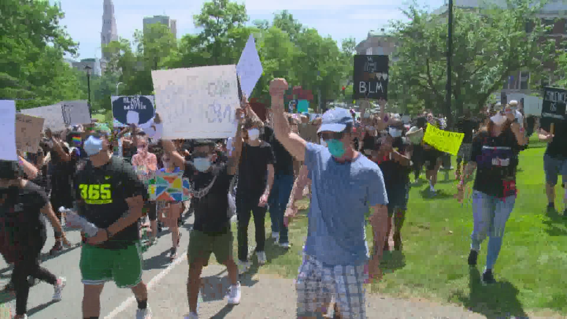 A rally inspired by the killing of George Floyd happened alongside one seeking earlier lifting of COVID-19 restrictions in Connecticut.