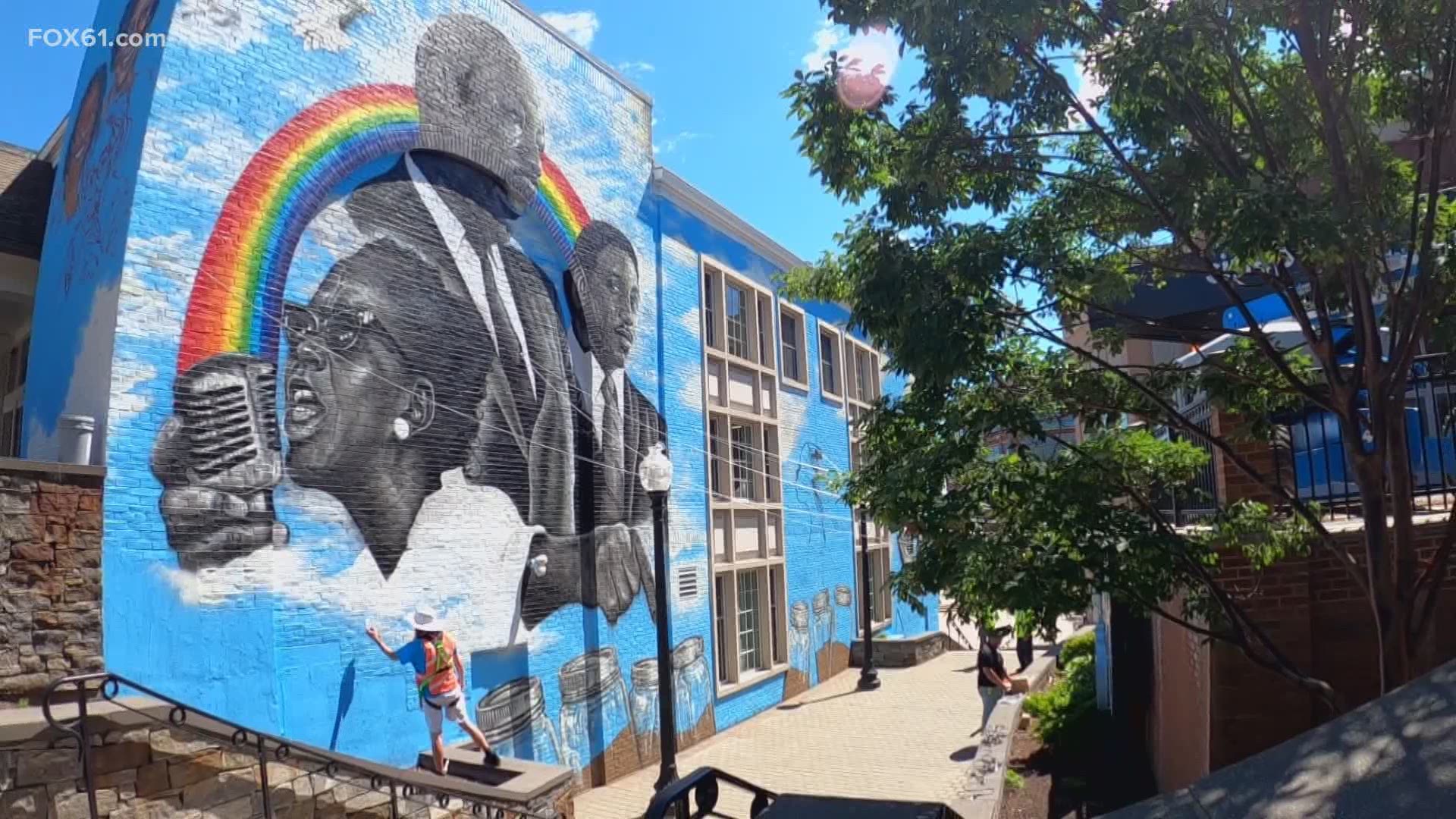 After nearly a week, artist Corey Pane – the steady hand behind the mega mural on Pearl Street in Downtown Hartford – is putting the finishing touches on the mural.